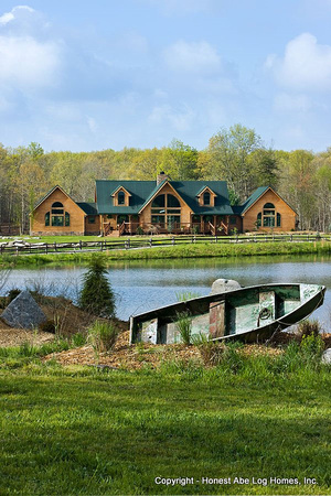 Exteror, vertical, front scene setter with row boat and pond in foreground, Wilson residence, Crossville, Tennessee; Honest Abe Log Homes