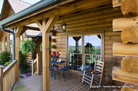 Exterior, horizontal, rear porch with table and chairs set for tea, Swift residence, Honest Abe Log Homes, Allgood, TN