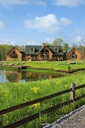 Exterior, vertical, front elevation with wood fence and pond in foreground, Wilson residence, Crossville, Tennessee; Honest Abe Log Homes