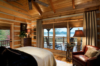 Interior, horizontal, guest bedroom looking out to deck and view of Five Fingers Lake, DeSocio residence, Paris, Tennessee; Honest Abe Log Homes