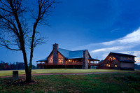 Exterior, horizontal, rear 3/4 view at twilight with house and garage with bonus room, DeSocio residence, Paris, Tennessee; Honest Abe Log Homes