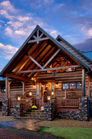 Exterior, vertical, front porch and entry at twilight, DeSocio residence, Paris, Tennessee; Honest Abe Log Homes