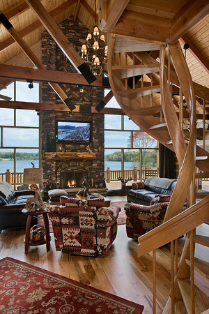 Interior, vertical, living room toward fireplace and windows with circular stairway in the foreground, DeSocio residence, Paris, Tennessee; Honest Abe Log Homes